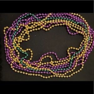 Mardi gras beads in purple, green and gold.
